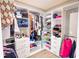 Spacious walk-in closet featuring custom shelving with clothing and shoe storage and hanging racks at 1315 Olympia Park Cir, Ocoee, FL 34761
