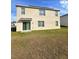 Back of house on a lawn at 10601 Burlwood Dr, Leesburg, FL 34788