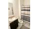 Bathroom featuring a shower with a shower curtain and single vanity at 10601 Burlwood Dr, Leesburg, FL 34788