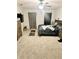 Bedroom featuring carpeted floors, ceiling fan and a large window providing natural light at 10601 Burlwood Dr, Leesburg, FL 34788