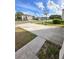 Concrete driveway leading to a basketball hoop at 10601 Burlwood Dr, Leesburg, FL 34788