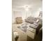 Spacious living room area with multiple seating options and natural light at 10601 Burlwood Dr, Leesburg, FL 34788