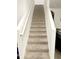 Carpeted staircase offers a transition to the home's upper level at 10601 Burlwood Dr, Leesburg, FL 34788