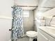 This bathroom features a walk-in shower with tiled walls and a patterned shower curtain at 2341 Weber St, Lakeland, FL 33801