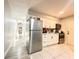 Efficient kitchen with white cabinets, stainless appliances, and ample counter space, adjacent to a hallway at 2341 Weber St, Lakeland, FL 33801