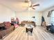 Bright living room featuring wood floors, a ceiling fan, and a door to the outside at 2341 Weber St, Lakeland, FL 33801