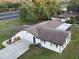 Aerial view of house featuring a large lawn, driveway and screened in patio at 1968 Pleasant Hill Rd, Kissimmee, FL 34746