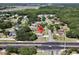 An aerial view of the property on a corner lot with lush trees, close to shopping and dining areas at 1968 Pleasant Hill Rd, Kissimmee, FL 34746