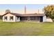 View of the back of the house that features a screen patio and a big backyard at 1968 Pleasant Hill Rd, Kissimmee, FL 34746