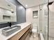 Modern bathroom featuring a stylish vessel sink, a large mirror, and glass-enclosed shower with updated tile at 1968 Pleasant Hill Rd, Kissimmee, FL 34746