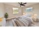 Bright bedroom with two windows, a cozy bed, and stylish décor that's move-in ready at 1968 Pleasant Hill Rd, Kissimmee, FL 34746