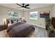 Comfortable bedroom featuring a ceiling fan and natural light from two windows at 1968 Pleasant Hill Rd, Kissimmee, FL 34746