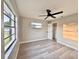 Sun-filled bedroom featuring wood-look flooring, a ceiling fan, and windows with natural light at 1968 Pleasant Hill Rd, Kissimmee, FL 34746