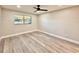 Bright, empty bedroom with modern flooring, neutral walls, ceiling fan, and a window for natural light at 1968 Pleasant Hill Rd, Kissimmee, FL 34746