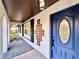 Welcoming entrance featuring a blue door, decorative tiles, and modern lighting at 1968 Pleasant Hill Rd, Kissimmee, FL 34746
