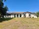 Charming one-story home with a well-maintained lawn and unique architectural elements at 1968 Pleasant Hill Rd, Kissimmee, FL 34746