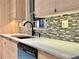 Modern kitchen features sleek, light wood cabinets, a stylish mosaic backsplash, and updated countertops at 1968 Pleasant Hill Rd, Kissimmee, FL 34746