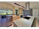 Well-lit kitchen with stainless steel refrigerator, island cooktop, and modern cabinetry in an open layout at 1968 Pleasant Hill Rd, Kissimmee, FL 34746