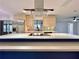Open-concept kitchen featuring a large island with cooktop and stainless steel appliances, with abundant cabinet space at 1968 Pleasant Hill Rd, Kissimmee, FL 34746