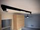 Modern track lighting fixture in a room with light wood cabinets and a view of a ceiling fan in another room at 1968 Pleasant Hill Rd, Kissimmee, FL 34746
