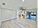 Open floor plan with light wood-look flooring, connecting living area to the modern kitchen at 1968 Pleasant Hill Rd, Kissimmee, FL 34746