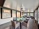 Spacious sunroom with table, chairs, ceiling fan and natural light from many windows at 1968 Pleasant Hill Rd, Kissimmee, FL 34746