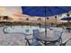 A community pool with blue umbrellas and tables, a resort-like setting under an evening sky at 2038 Babbling Brook Blvd, Auburndale, FL 33823