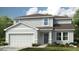 Charming two-story home featuring manicured lawn and a two-car garage at 2084 Babbling Brook Blvd, Auburndale, FL 33823