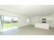 Open-concept living space with sliding glass doors to the patio and kitchen island at 2084 Babbling Brook Blvd, Auburndale, FL 33823