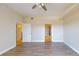 Bright, empty bedroom featuring wood floors, neutral walls, and an open doorway to the ensuite at 2305 Edgewater Dr # 1606, Orlando, FL 32804