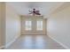 Light-filled bedroom with a ceiling fan and two bright windows at 2305 Edgewater Dr # 1606, Orlando, FL 32804