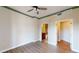 Bright bedroom with decorative green trim, open doorways and wood-style laminate flooring at 2305 Edgewater Dr # 1606, Orlando, FL 32804