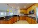 Modern kitchen featuring wooden cabinets, granite countertops, stainless appliances and breakfast bar at 2305 Edgewater Dr # 1606, Orlando, FL 32804