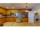 Well-equipped kitchen featuring stainless steel appliances, light-wood cabinets and tiled flooring at 2305 Edgewater Dr # 1606, Orlando, FL 32804