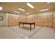 Locker room with wooden lockers and a table in the center at 2305 Edgewater Dr # 1606, Orlando, FL 32804