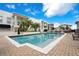 Bright community pool surrounded by palm trees and lush landscaping at 2305 Edgewater Dr # 1606, Orlando, FL 32804