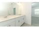 Bathroom featuring double sinks, a large mirror, and white cabinetry at 2559 Driftwood St, Auburndale, FL 33823