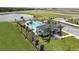 Community pool area with lush landscaping and clubhouse at 2559 Driftwood St, Auburndale, FL 33823