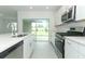 Bright modern kitchen featuring stainless appliances, white cabinetry, and natural light at 2559 Driftwood St, Auburndale, FL 33823