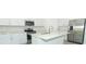 Bright, well-appointed kitchen with stainless steel appliances, white cabinetry, and a central island at 2559 Driftwood St, Auburndale, FL 33823