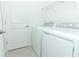 Laundry room with white washer and dryer at 2559 Driftwood St, Auburndale, FL 33823