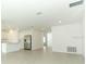 Open-concept living area with tile floors flowing into a kitchen, offering modern living and ample space at 2559 Driftwood St, Auburndale, FL 33823