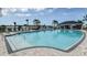 Inviting community pool with lounge chairs and lush landscaping, offering a perfect spot for relaxation and recreation at 2559 Driftwood St, Auburndale, FL 33823