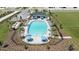 An aerial shot showcasing a community pool with lounge chairs, umbrellas, a covered seating area, and landscaped grounds at 2559 Driftwood St, Auburndale, FL 33823