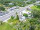Aerial view of property at an intersection with local businesses and lush greenery at 800 N Church Ave, Mulberry, FL 33860