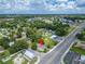 Aerial view showcasing property's location near a main road, green spaces, and surrounding neighborhood amenities at 800 N Church Ave, Mulberry, FL 33860