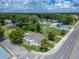 Aerial view showcases property's location near street and the surrounding neighborhood with businesses at 800 N Church Ave, Mulberry, FL 33860