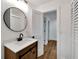 Bathroom with modern sink and vanity featuring dark hardware and a barn door style cabinet at 800 N Church Ave, Mulberry, FL 33860