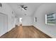 Bright bedroom with white walls and light wood floors, featuring two windows and closet space at 800 N Church Ave, Mulberry, FL 33860