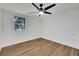 Bedroom with wood floors, a ceiling fan, and window with a view of the outdoors at 800 N Church Ave, Mulberry, FL 33860